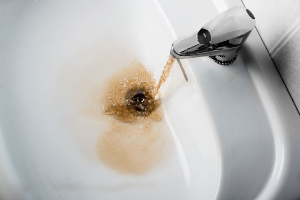 bathroom-faucet-with-brown-running-water