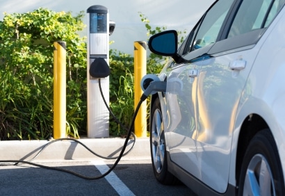 Electric vehicle charging at a public station.